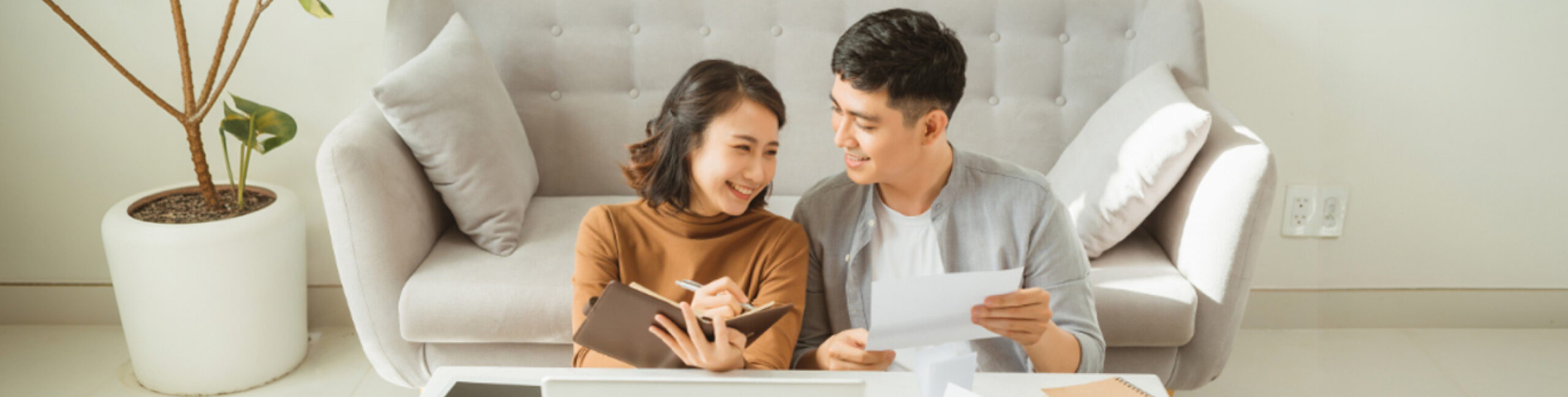 Couples smiling in front of their new home