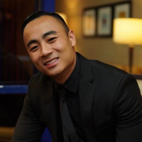 Headshot of Doan (Dante) Dang, Account Executive at Fastrack Rate, smiling in a dark suit